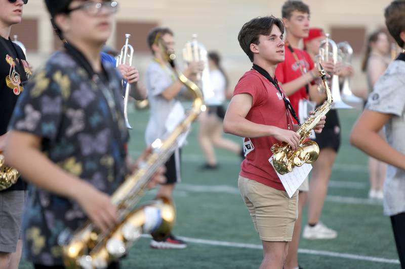 Members of the Batavia High School marching band walk through their choreography with their instruments during band camp at the school on Tuesday, July 30, 2024.