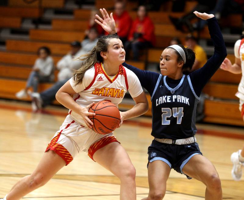 Batavia’s Brooke Carlson (left) gets past Lake Park’s Gabi Burgess (24) during a home game on Tuesday, Dec. 6, 2022.