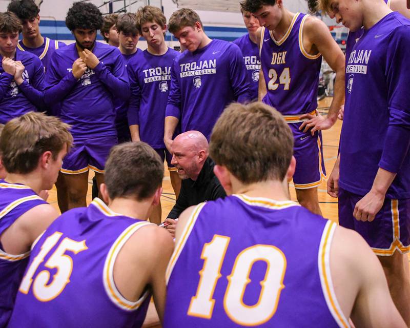 Downers Grove North's head coach James Thomas talks with the team between quarters on Saturday Dec. 21, 2024, while taking on crosstown rival Downers Grove South held at Downers Grove South High School.