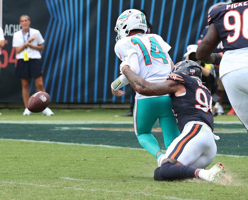 Chicago Bears defensive end Austin Booker sacks Miami Dolphins quarterback Quinn Ewers and forces a fumble Sunday, Aug. 10, 2025, during their game at Soldier Field in Chicago.