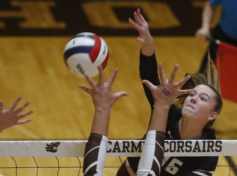 Prairie Ridge's Addy Grider spikes the ball over a Carmel block during the IHSA Class  3A Carmel Sectional championship volleyball match on Thursday, Nov. 6, 2025, at Carmel High School, in Mundelein.