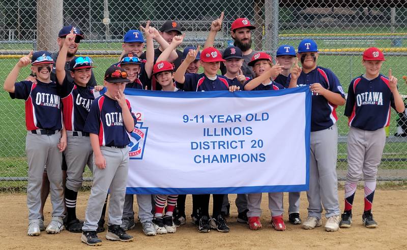 The Ottawa American 11-Year-Old All-Stars pose with their District 20 championship banner.