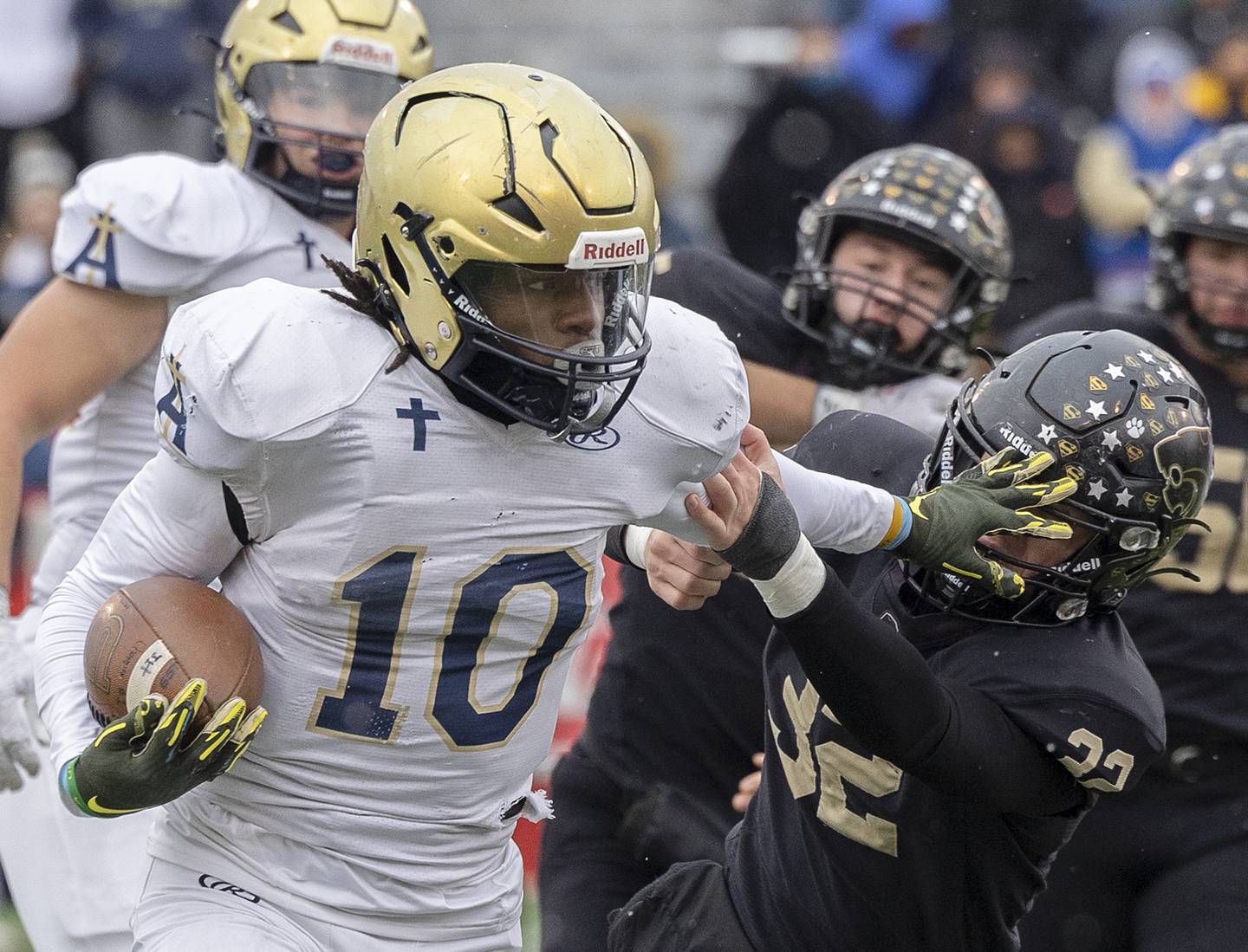 Althoff Catholic’s Dierre Hill Jr. stiff arms Lena-Winslow's Jimmy Goebel Friday, Nov. 29, 2024, in the class 1A football state final.