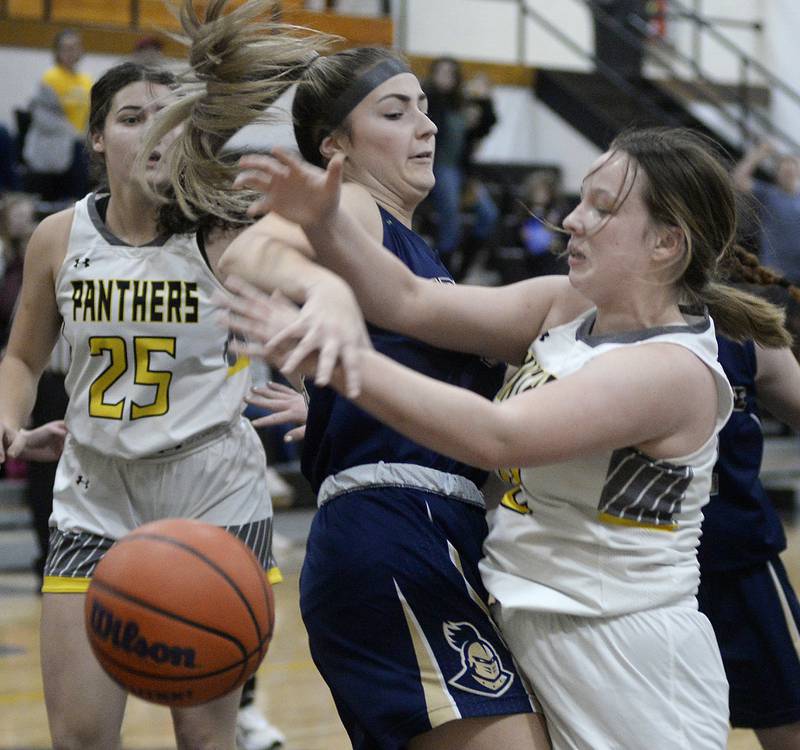 Marquette’s Eva MCallum knocks the ball away from Putnam County’s Mikenna Boyd on a shot attempt in the 1st period on Wednesday, Dec. 14, 2022 at Putnam County High School.