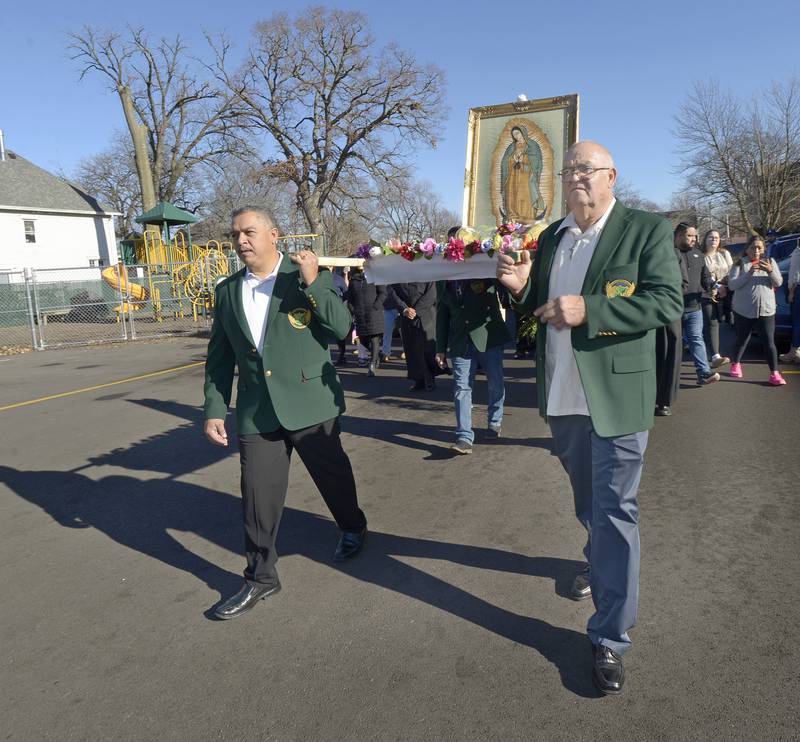 A procession works around St Michael’s School with an image of Our Lady of Guadalupe following Mass on Sunday, Dec. 8, 2024, at St Michael the Archangel Church, Streator. The image carried by the ushers appeared on a peasant's garment (still preserved in Mexico City) and its symbolic message set off mass conversions to Christianity in Mexico and the Americas.