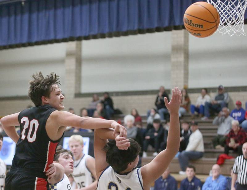 Earlville's Grady Harp misses a pass as it sails out of bounce over the head of Marquette's Matt Graham on Friday, Jan. 3, 2025 in Bader Gym at Marquette High School.