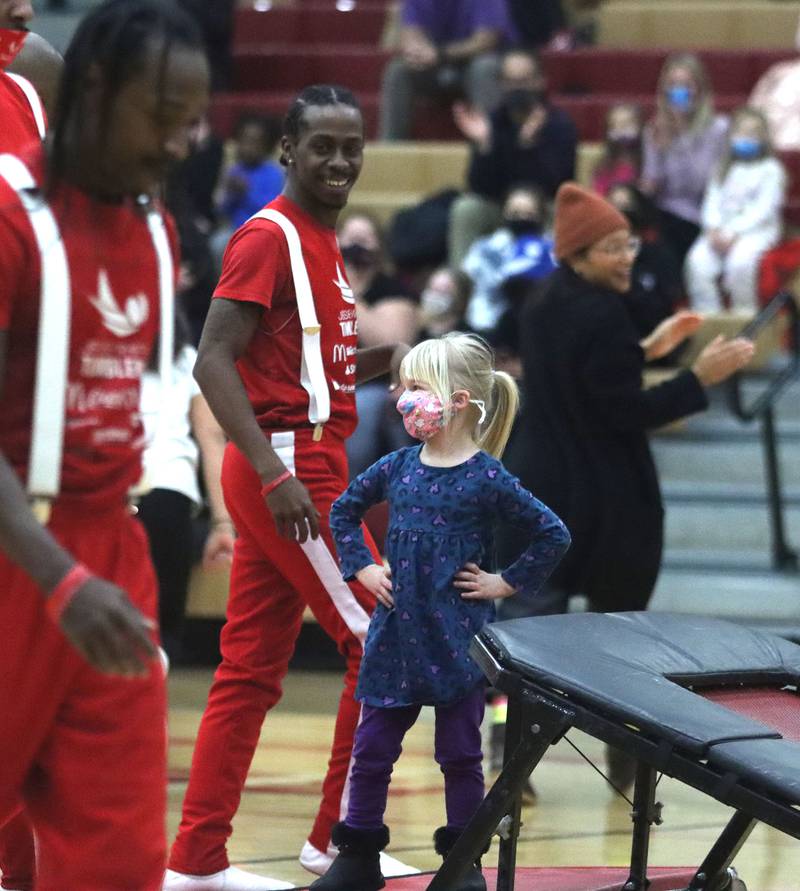 Emerson Pocztowski, 3, of Huntley, delights the Jesse White Tumblers with her reaction to their leaps during the Black History Month event, titled “Celebrating Black Stories: Narratives on Identity, Belonging and Community,” which was held Feb. 24, 2022, at Huntley High School.