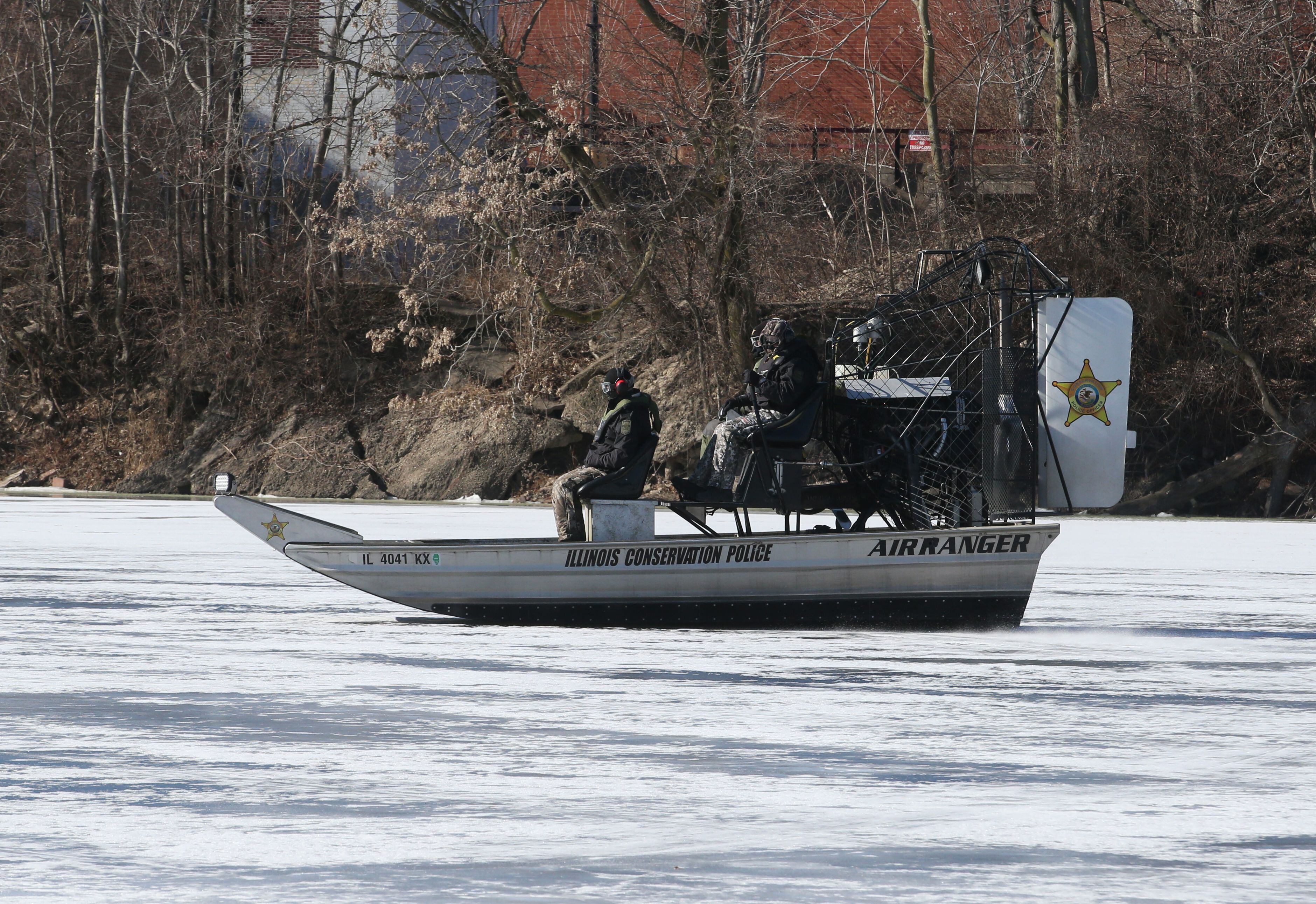 Illinois Department of Natural Resources Conservation Police officers use an airboat to glide on top of ice during a training mission on Monday, Jan. 27, 2025, along the Fox River in Ottawa.