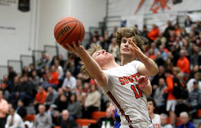 Wheaton Warrenville South’s Colin Moore attempts a shot during a game against Geneva in Wheaton on Friday, Jan. 27, 2023.