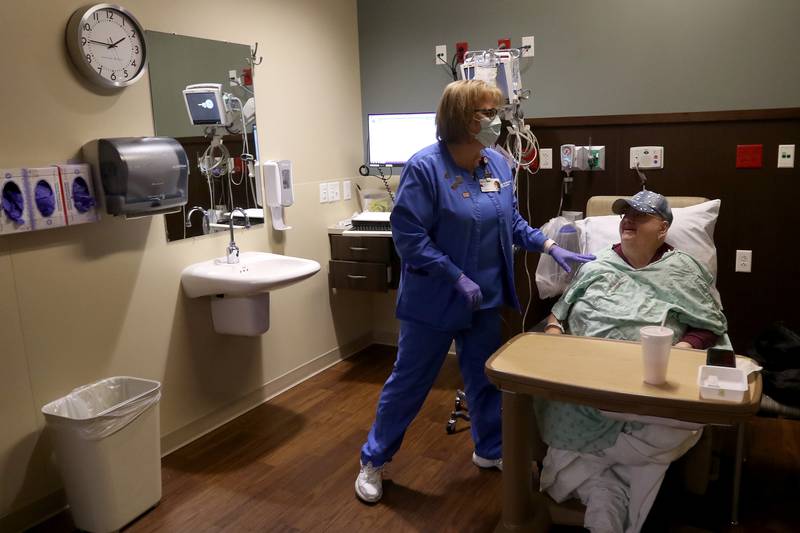Oncology nurse Mary Schneider helps chemotherapy patient Stella Sulkowski of Woodstock at Northwestern Medicine Huntley Campus on Thursday, March 4, 2021 in Huntley.