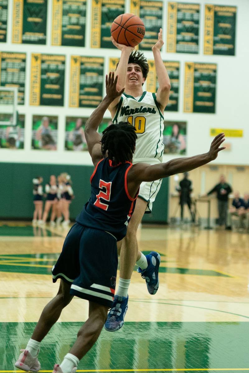Waubonsie Valley's Eric Chtilianov (10) shoots the ball in the post over Oswego’s Armani Hunter (2) during a Waubonsie Valley 4A regional semifinal basketball game at Waubonsie Valley High School in St.Charles on Wednesday, Feb 22, 2023.