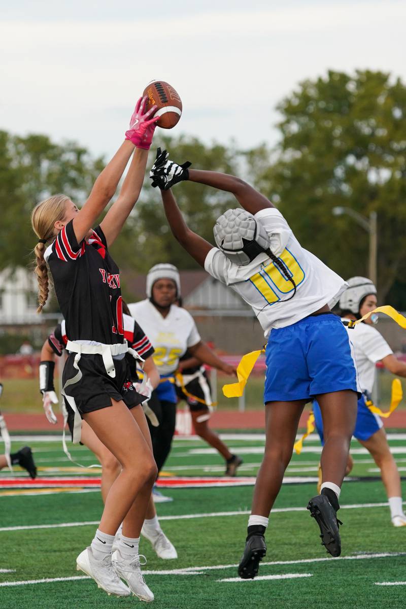Yorkville's Grace Niles (left) intercepts a pass intended for Joliet Central's Ta’tyanna Nicks (right) during a flag football game at Yorkville High School on Monday, Sep 23, 2024.