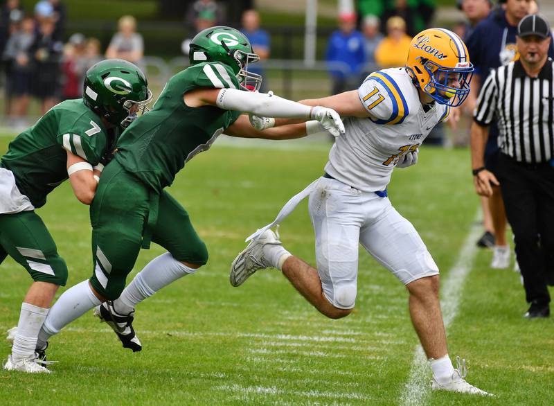 Glenbard West's Eli Limouris and Will Meyer drive Lyons Township's Noah Pfafflin out of bounds after a catch during a game on Sep. 16, 2023 at Glenbard West High School in Glen Ellyn.