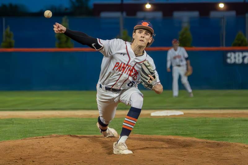 Oswego’s Dominic Stringham (8) delivers a pitch against Oswego East during a baseball game at Oswego High School on Tuesday, May 9, 2023.