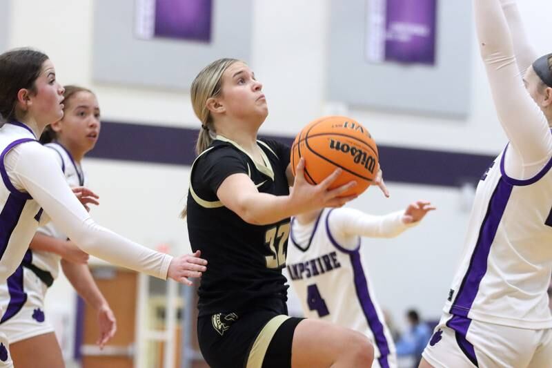 Sycamore’s Quinn Carrier works under the hoop in varsity girls basketball on Friday, Jan. 3, 2025, at Hampshire High School in Hampshire.