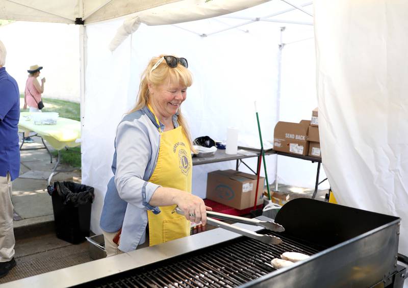Deb Dickinson cooks bratwursts in the Lions Club tent during the first day of the 2023 Swedish Days Festival on Wednesday, June 21, 2023. No one was injured.