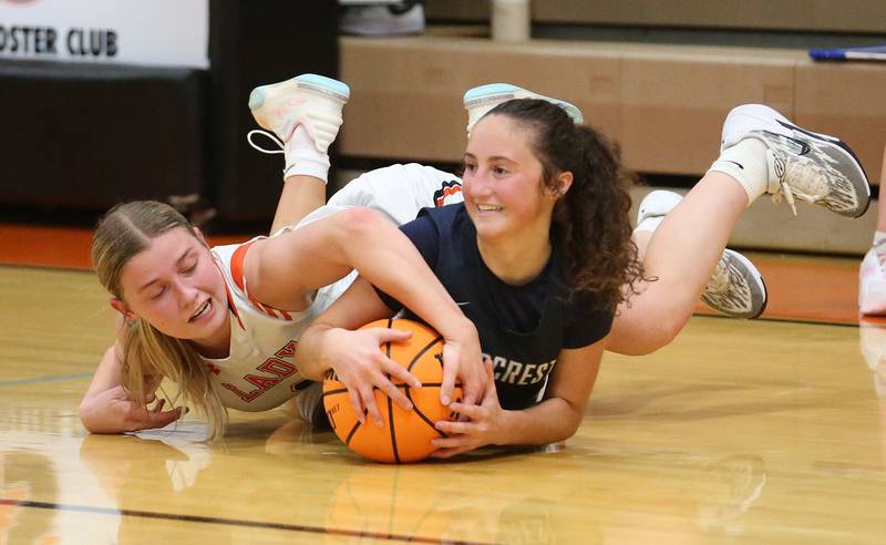 Flanagan-Cornell/Woodland's Kora Edens forces a jump ball with Fieldcrest's Macy Gochanour during the Falcon-Irish Thanksgiving Tournament on Monday, Nov. 18, 2024 at Flanagan High School.