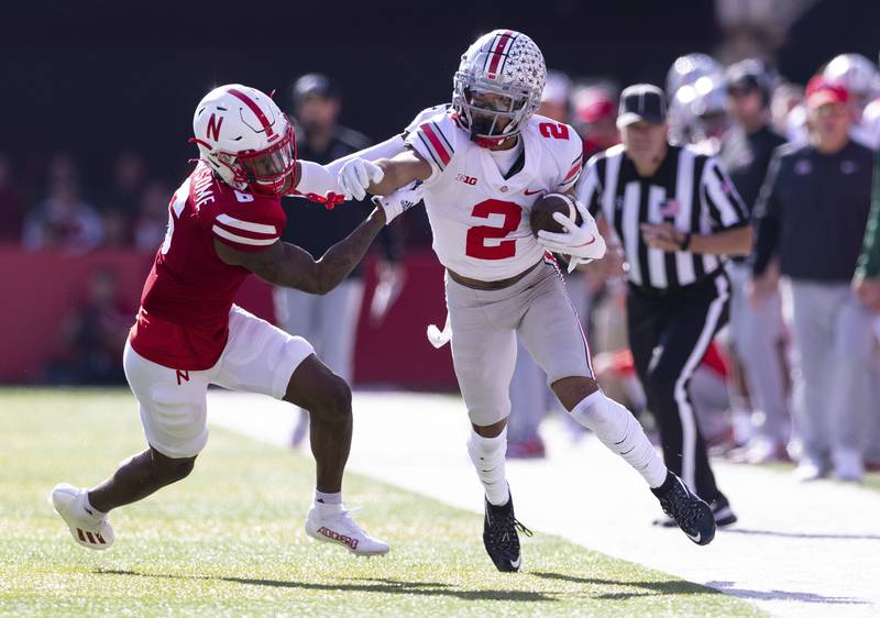 Ohio State wide receiver Chris Olave carries a pass reception against Nebraska cornerback Quinton Newsome on Nov. 6, 2021 at Memorial Stadium in Lincoln, Neb.