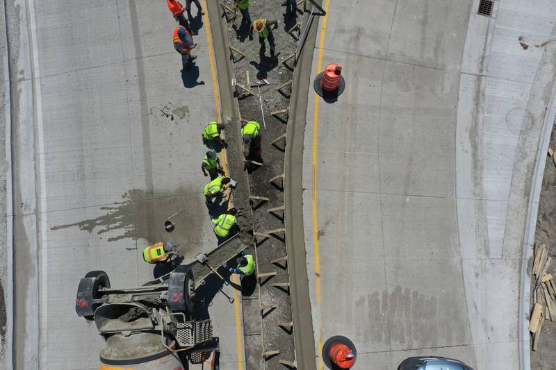 Crews pour concrete on the northern approach to the roundabout on Tuesday, May 16, 2023 at the intersection of Illinois Route 178 and U.S. Route 6 in Utica.