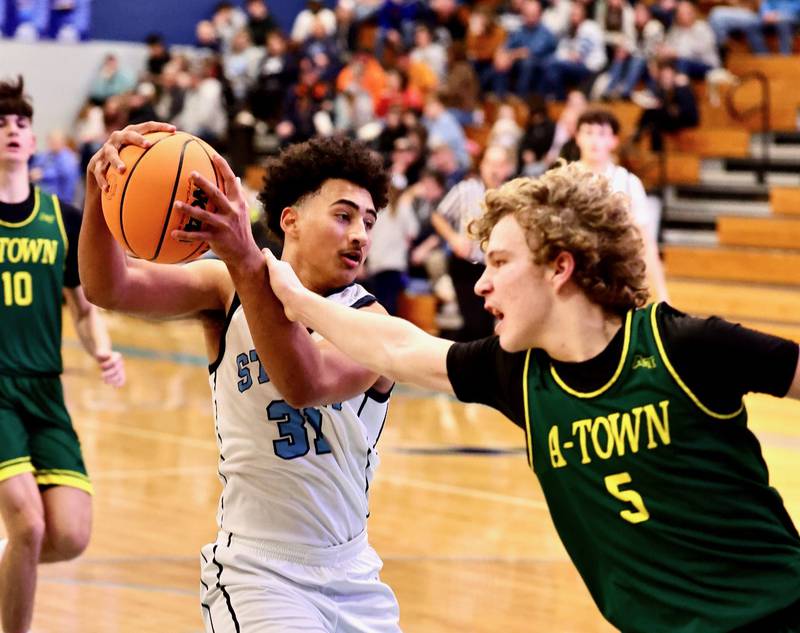 Bureau Valley's Dakari Martin plays keep-away from Abingdon-Avon's Ryker Darst Friday at the Storm Cellar. A-Town won 47-45.