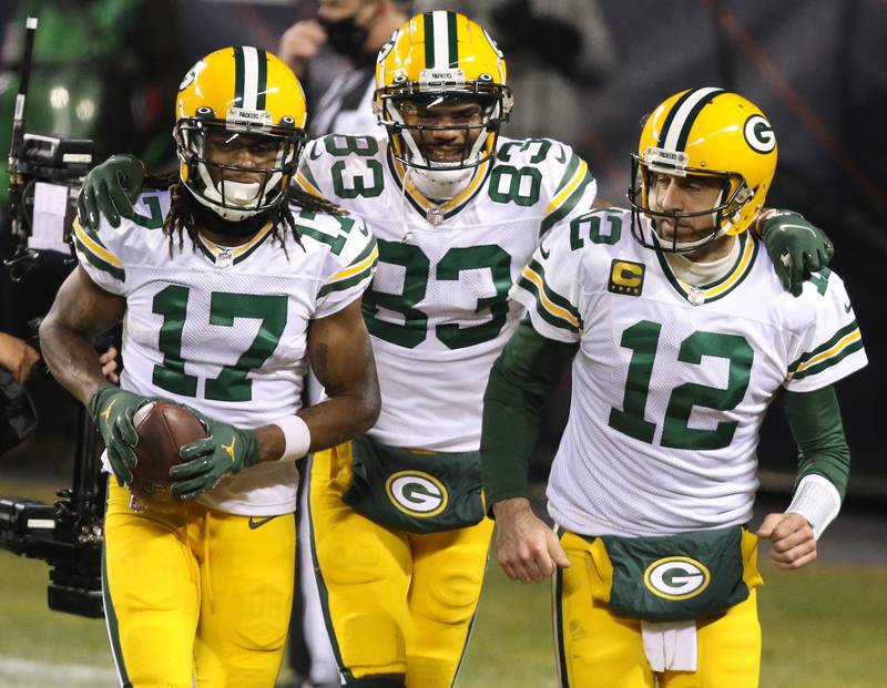 Green Bay Packers wide receiver Davante Adams (17), wide receiver Marquez Valdes-Scantling (83) and quarterback Aaron Rodgers (12) celebrate after Rodgers connected with Adams for a touchdown during their game Sunday at Soldier Field in Chicago.