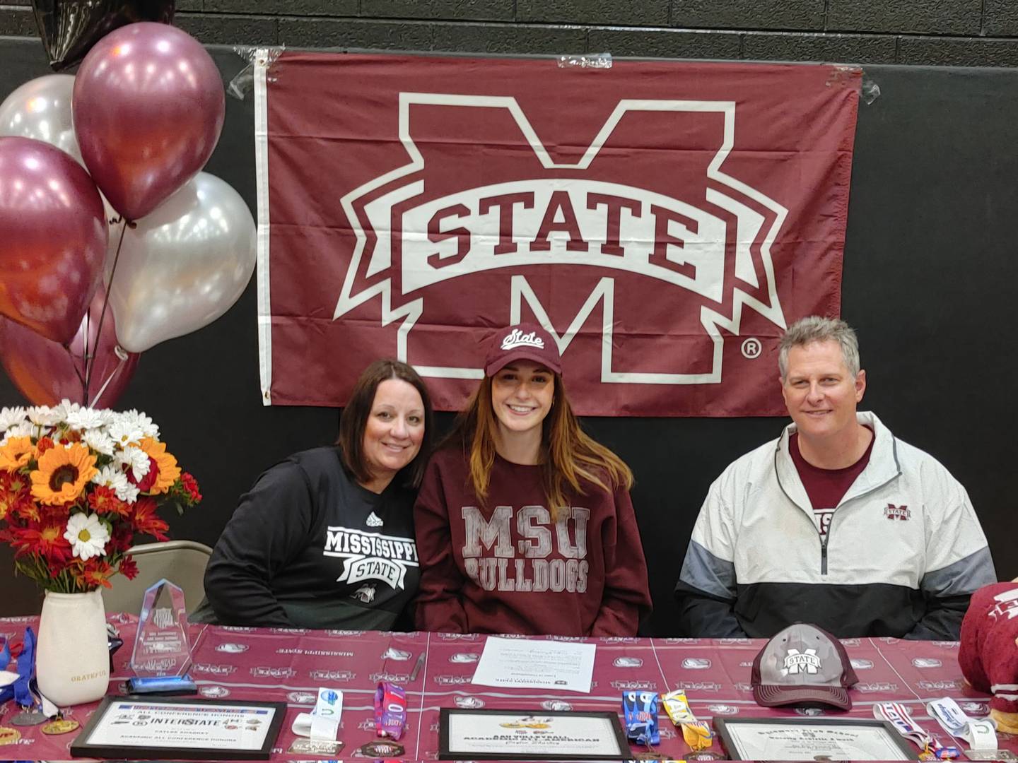 Caylee Sharkey poses with her family after the Sycamore volleyball player signed her letter of intent to play for Mississippi on Wednesday, Nov. 10, 2021.