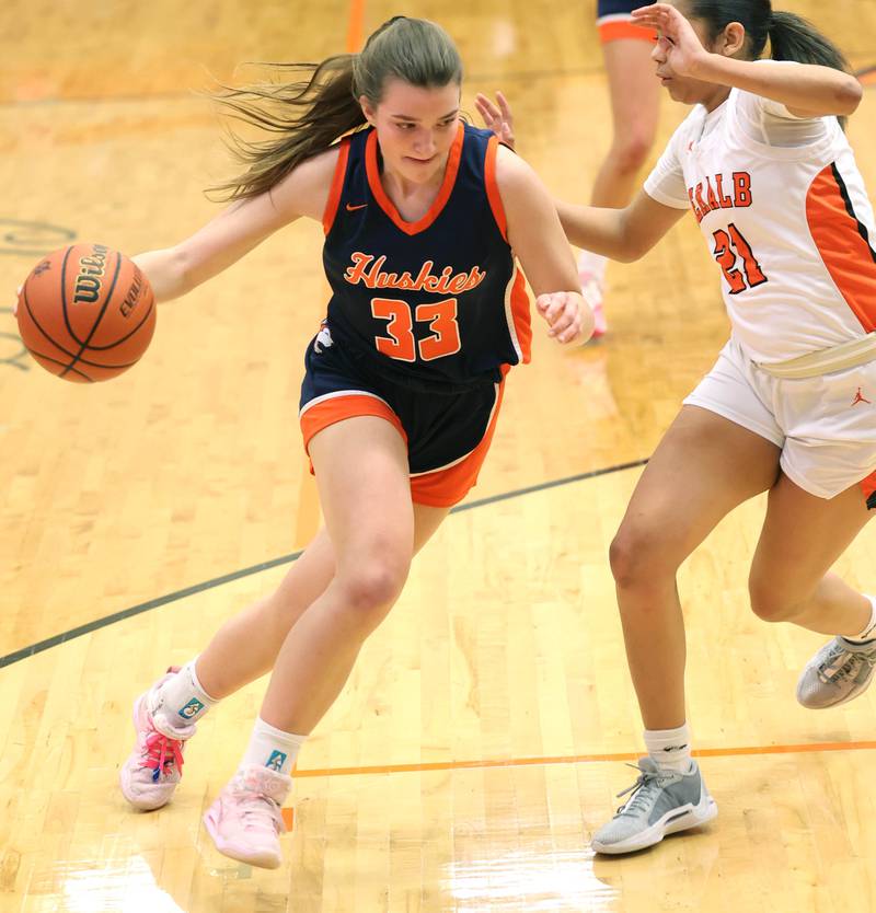 Naperville North's Ema Gilvydis drives by DeKalb’s Alicia Johnson Monday, Jan. 22, 2024, during their game at DeKalb High School.