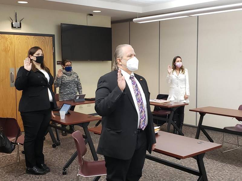 McHenry County Board member Jeffrey Thorsen (clockwise around the table) and newly elected McHenry County Board members Theresa Meshes, Jessica Phillips and Tanya Jindrich take their oath of office at the McHenry County Administration Building on Monday. New County Board member Tracie Von Bergen, not pictured, also was sworn in on Monday.