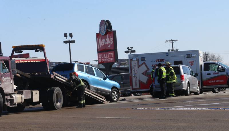 Peru Police, Fire and EMS work the scene of a two-vehicle crash at the intersection of Illinois Route 251 and 38th Street in Peru. The crash happened shortly after noon.