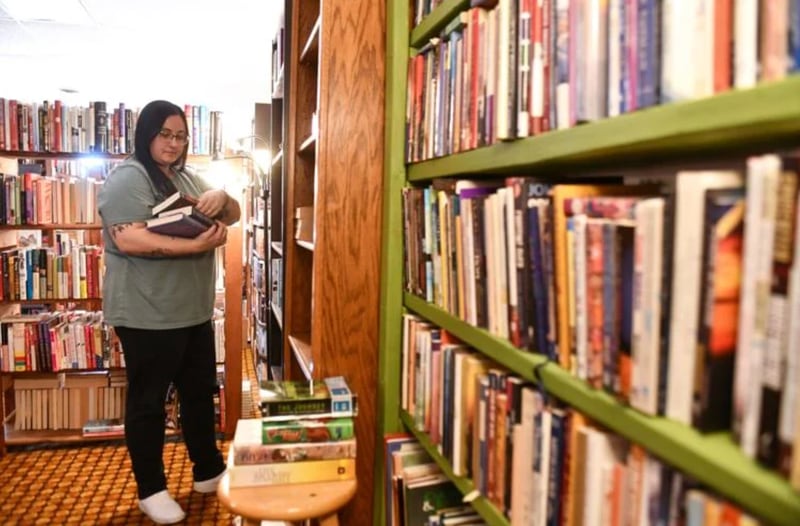 Nicole Barnett, owner of Rubber Rose Books & Print, adds to the shelves on Monday at the used bookstore location at 111 E. Court St. in downtown Kankakee. The shop was recently added to the Midwest Independent Booksellers Association’s 2025 Midwest Indie Bookstore Roadmap.