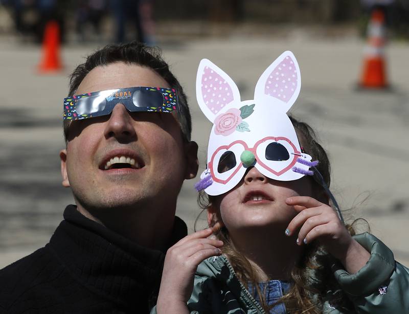 Kevin and Viva Smith watch the partial eclipse Monday, April 8, 2024, at the Crystal Lake Park District's Nature Center.