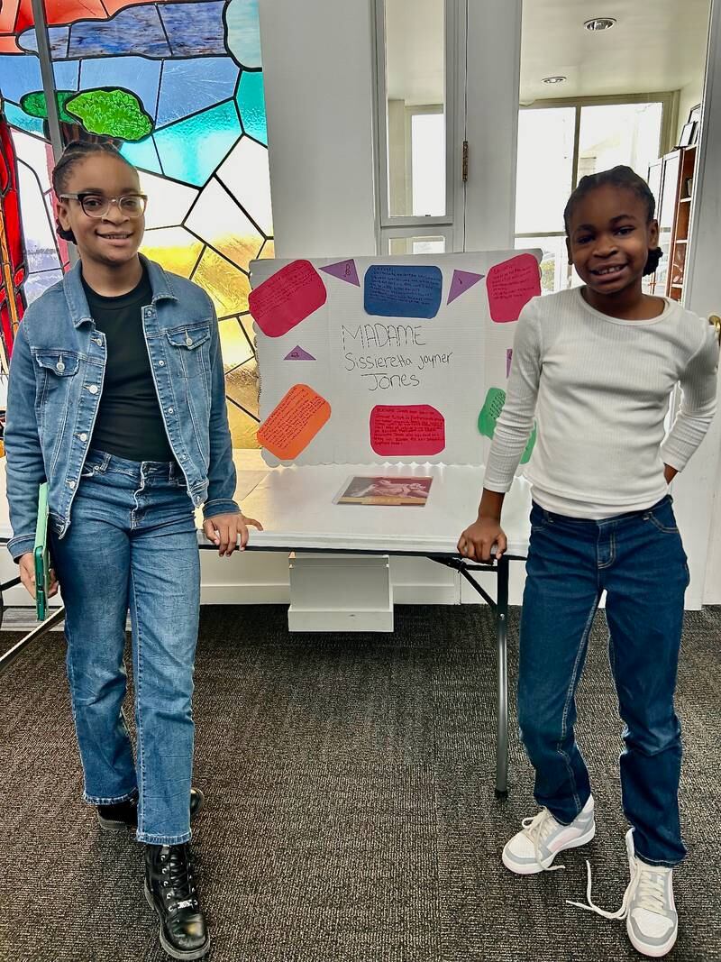 Journey Lewis poses next to a poster board detailing the life of soprano opera singer Madame Sissieretta Joyner Jones on Sunday, Feb. 16, 2025, at New Hope Missionary Baptist Church in DeKalb. The presentation was part of the church's annual Black History Month event "Displays of Excellence.”