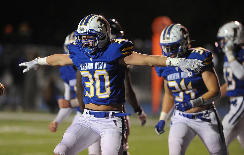 Wheaton North's Luke Beedle celebrates his second  touchdown of the first half against Hoffman Estates in the boys Class 7A football playoff game in Wheaton on Friday.