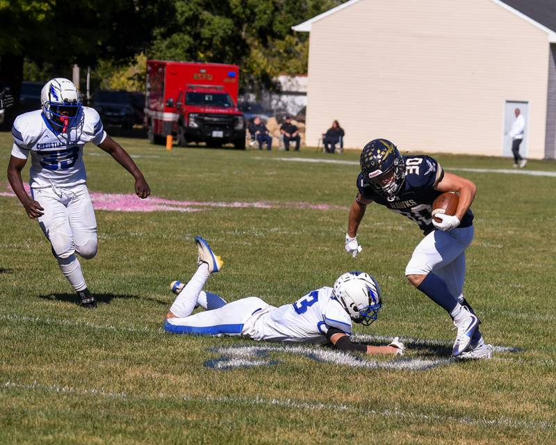 Hiawatha's Tim Pruitt (30) escapes the hands of Rockford Christian Life Ethan Vistine during the game on Saturday Oct. 11, 2025, held at Hiawatha High School.