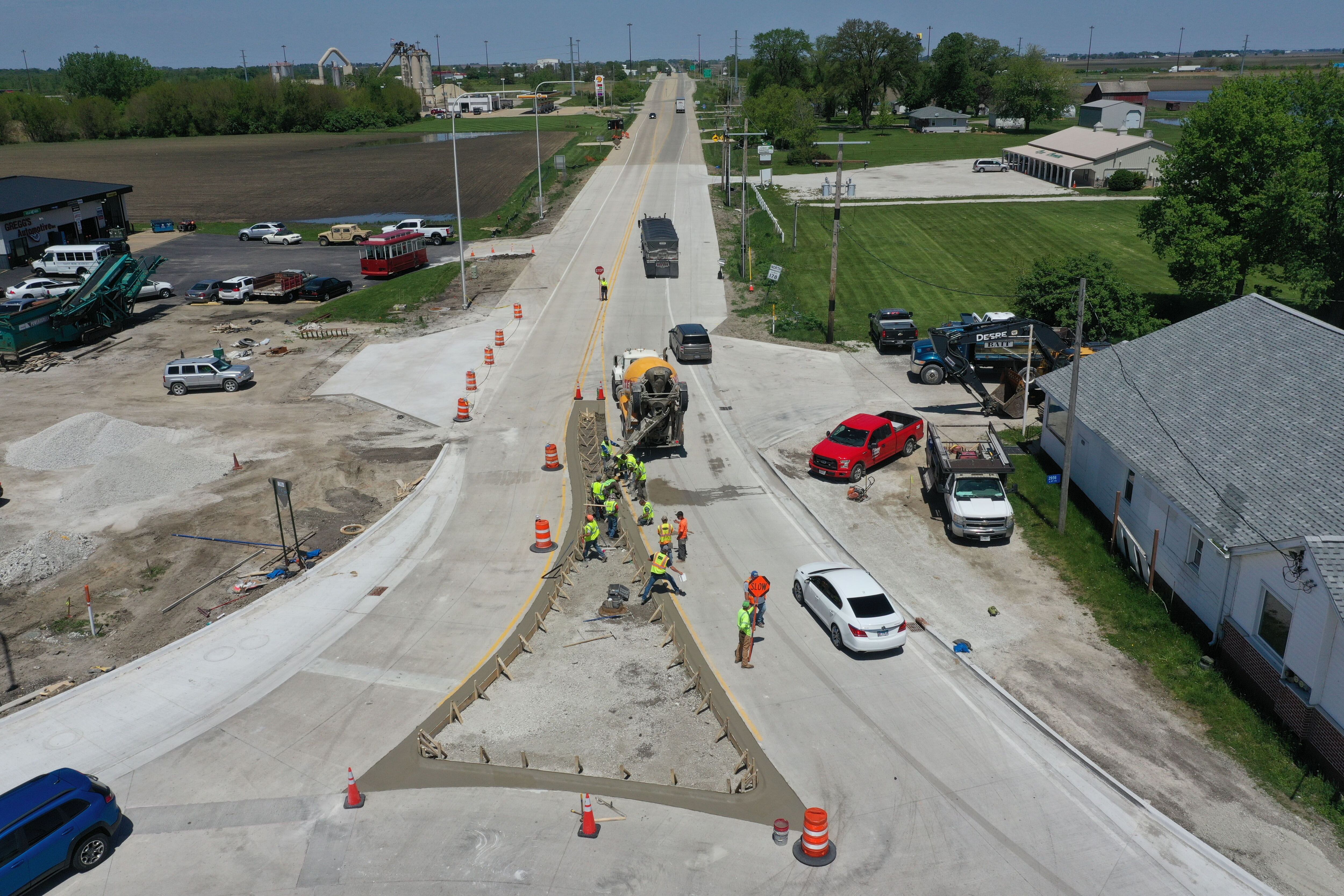 Crews pour concrete on the northern approach to the roundabout on Tuesday, May 16, 2023, at the intersection of Route 178 and U.S. 6 in Utica.