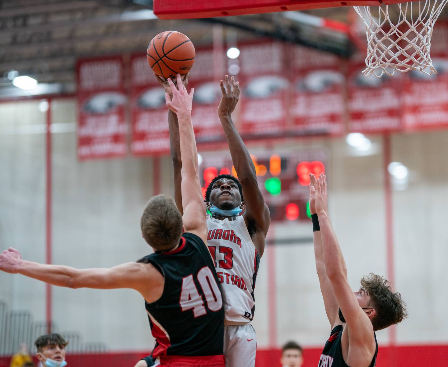 Timothy Christian's Ben VanderWal (40) defends the paint blocking a shot by Aurora Christian's Jabari Sisco (13) during a basketball game at Aurora Christian High School on Tuesday, Jan 25, 2022.