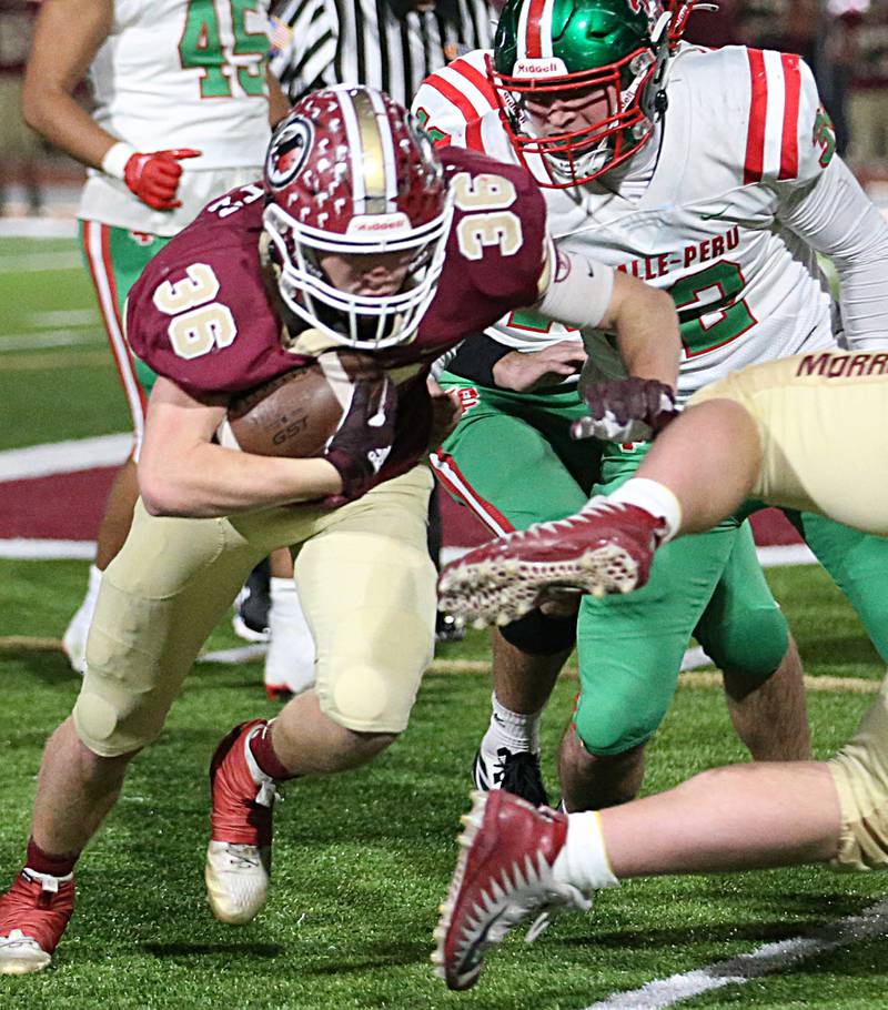 Morris's Jacob Swartz (36) runs avoids L-P's Connor Lorden (32) during the opening-round Class 5A playoff game Friday, Oct. 28, 2022, in Morris.