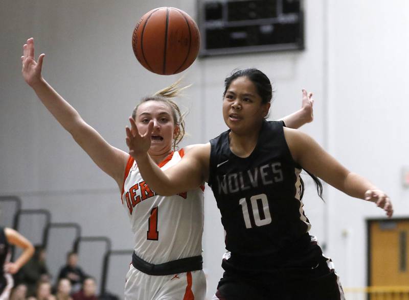 Prairie Ridge's Kate Pactol tries to saver the ball from going out of bounds in front of DeKalb's Ella Russell during a Northern Illinois Holiday Classic girls basketball  semifinal game Wednesday, Dec. 21, 2022, at McHenry High School.