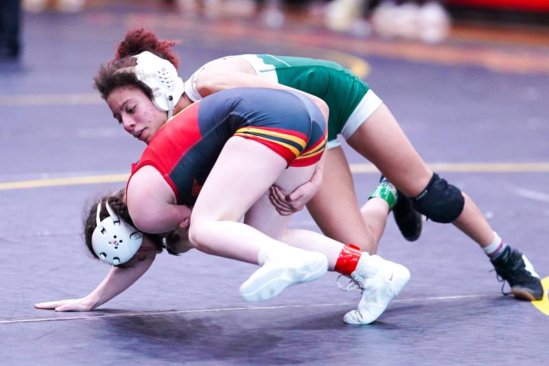 Glenbard West’s Alycia Perez (top) grapples with Batavia’s LIly Enos during their 100 pound championship match in the Schaumburg Girls Wrestling Sectional at Schaumburg High School on Saturday, Feb 10, 2024.