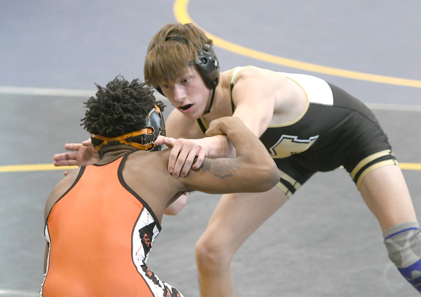 Polo's Wyatt Doty battles Freeport's Markel Baker during the 132-pound title match at the Polo Wrestling Invitational.