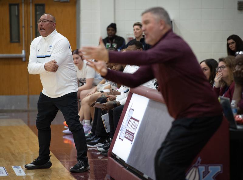 Kankakee's head girls basketball coach Kurt Weigt, left, and Morris's head coach Mike Lutz, foreground, talk to players on the court in a game on Tuesday, January 27, 2026.