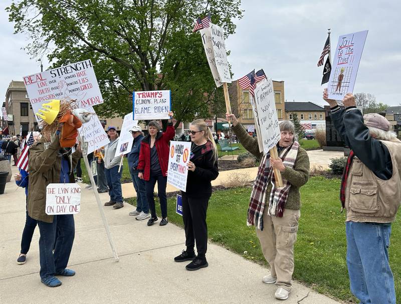 Attendees held signs at the May Day Rally on Thursday, May 1, 2025 in Oregon. The evening event was held around the historic Ogle County Courthouse.