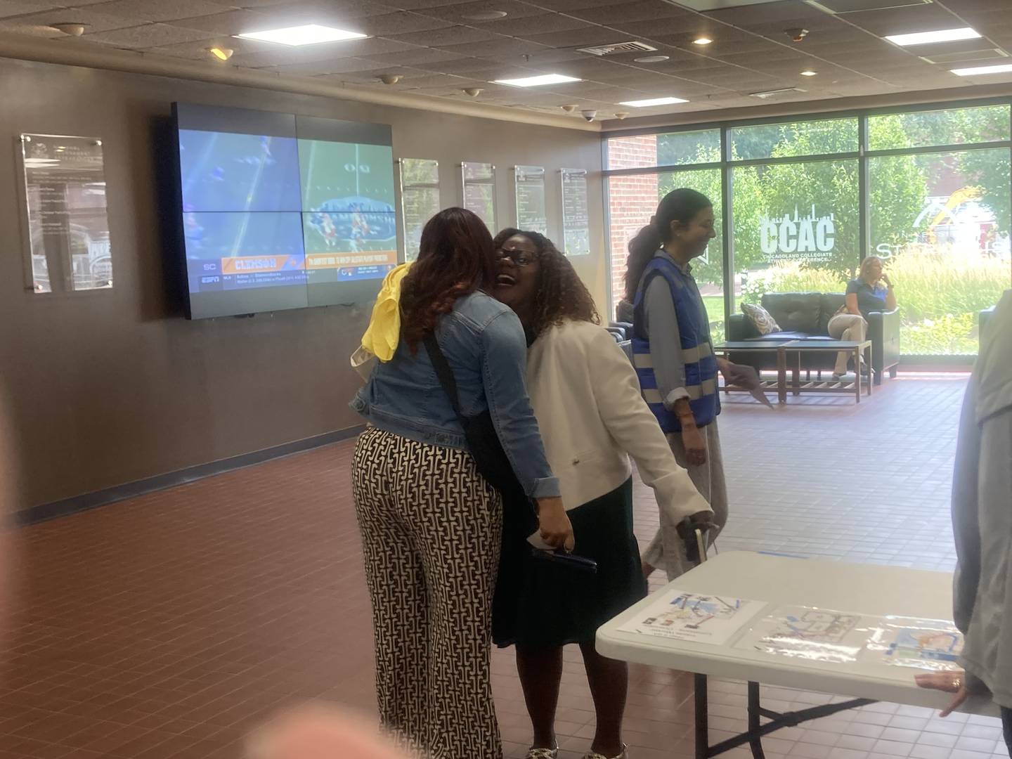 Two participants representing a parent and student complete the reunification drill with a hug during an emergency training program for first responders and local school personnel at University of St. Francis in Joliet on Wednesday, July 23, 2025.