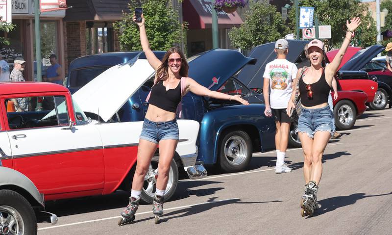 Courtney Sliga, (left) from Sycamore, and Jackie DeCleene, from DeKalb, rollerblade their way through the cars on State Street in Sycamore Sunday, July 31, 2022, during the 22nd Annual Fizz Ehrler Memorial Car Show.