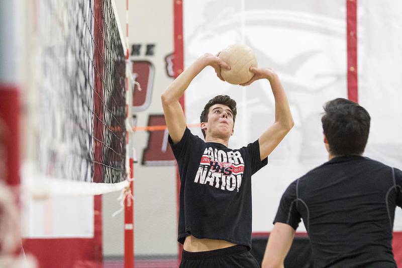 Huntley's Josh Bremer sets the ball during volleyball practice at Huntley High School Thursday, March 9, 2017.