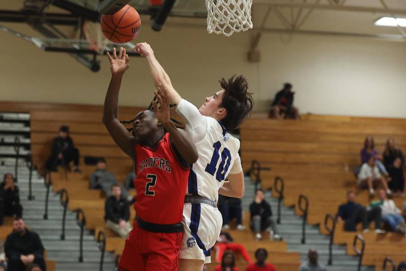 St. Francis’ Nathan Silagi blocks a shot by Bolingbrook’s DJ Strong in the Jack Tosh 2023 Holiday Classic on Wednesday, Dec.27th, 2023 in York.