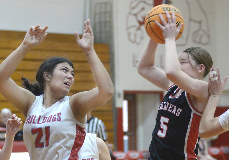 Earlville’s Bailey Miller (5) pulls down a rebound ahead of Streator’s Alexis Thomas (21) during the team's game Saturday, Jan. 10, 2026, in Streator's Pops Dale Gymnasium.