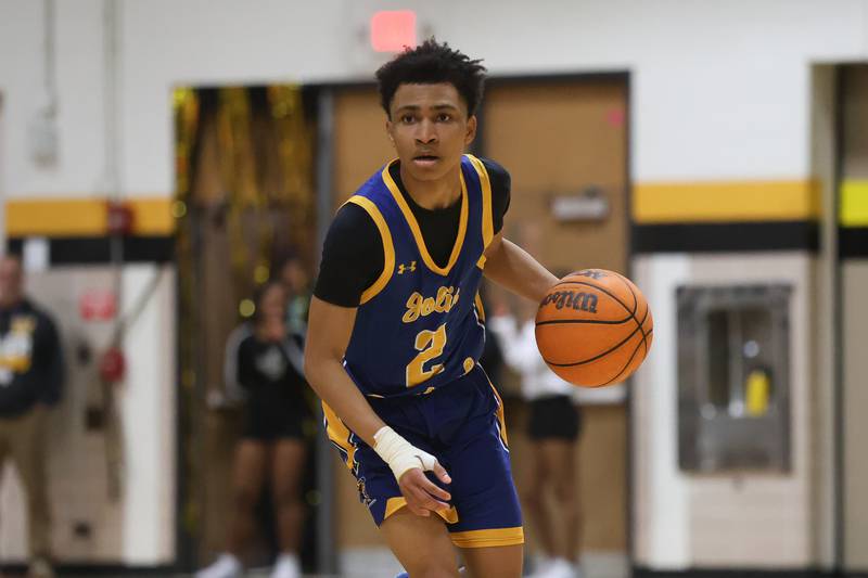 Joliet Central’s Kaden Henry works the ball midcourt against Joliet West on Tuesday, Feb. 17, 2026 in Joliet.