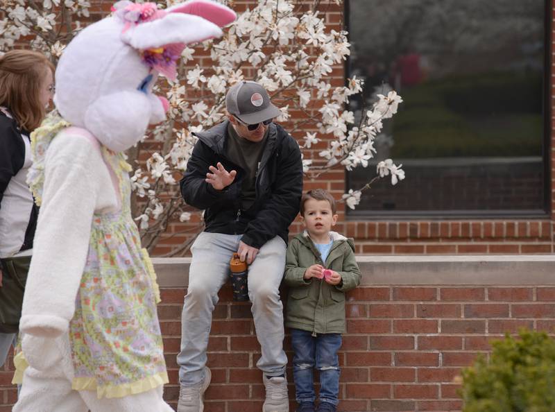 Henry Rady looks surprised while his dad Matt of Elk Grove watch the Easter Bunny walk past them during the Easter Egg Hunt held at Cantigny  Sunday April 13, 2025.