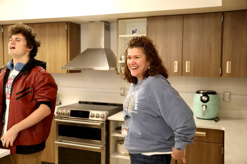 Yvette Harding, a paraprofessional for the St. Charles School District 303 Transition Program, shares a laugh with Tony Buttitta in the kitchen area of the program’s new facilities at Lincoln Elementary School in St. Charles.